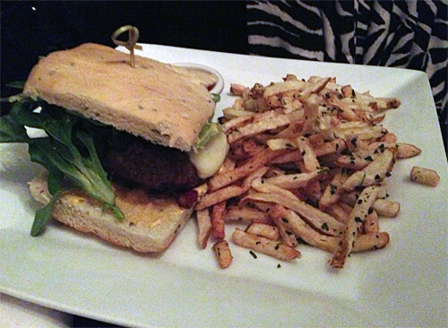 Umami Burger - Dashi soaked flank, spicy aioli, smoky cheese, bacon, caramelized onions and fries ($14)