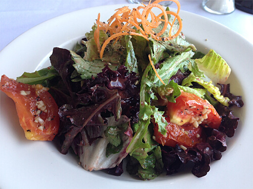 La Ronde Mixed Greens (mesculin greens, oven roasted roma tomatoes, carrot threads, raspberry balsamic dressing) at La Ronde Revolving Restaurant (Small - $9).