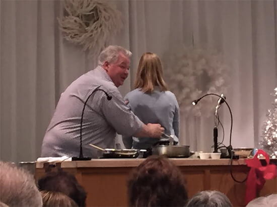 Michael demonstrating cuts of meat using Anna's back. 