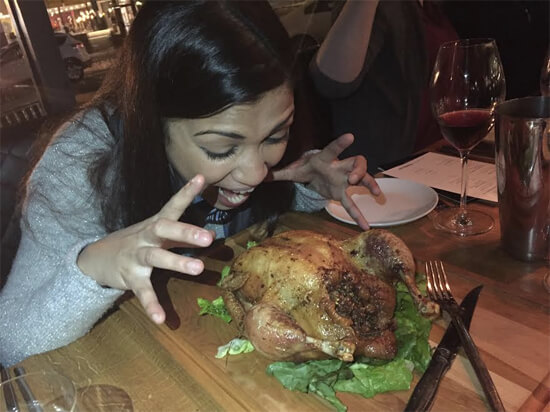 Michelle digging into the Whole Roasted Chicken! 