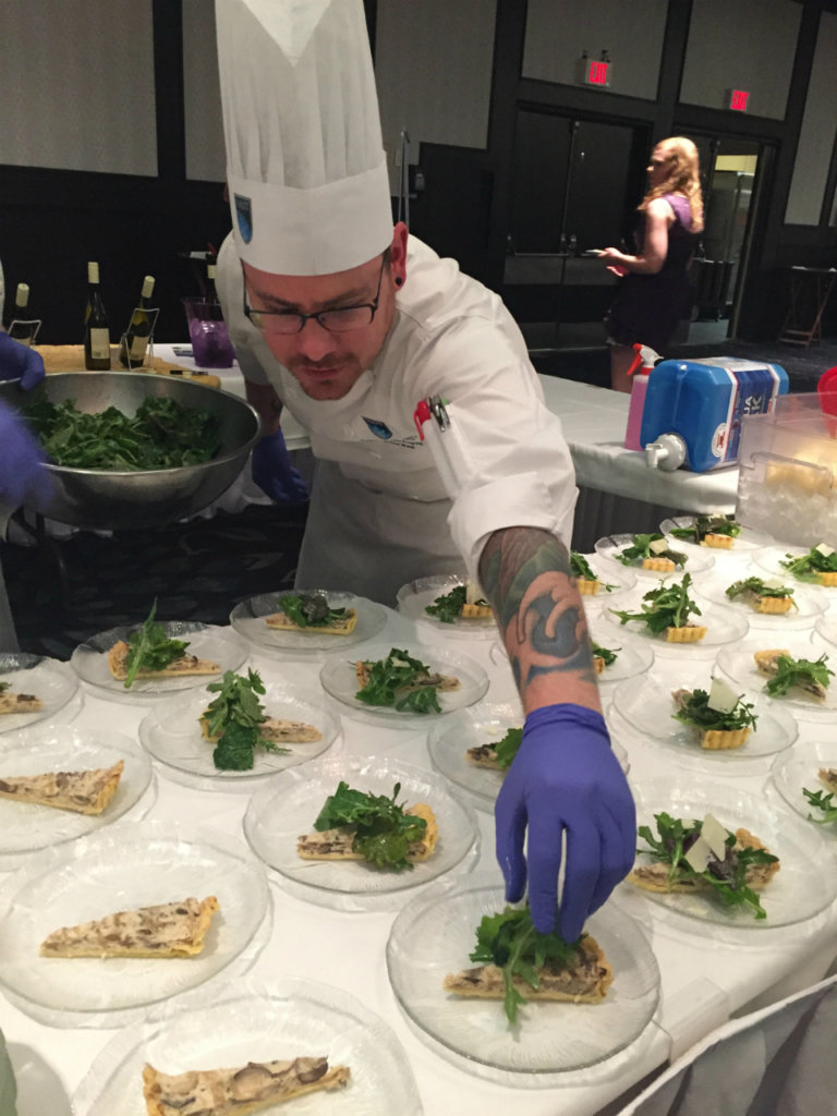 Joshua Ward with NAIT's School of Hospitality and Culinary Arts puts the finishing touches on their Cheesiry Fresco Tart. 