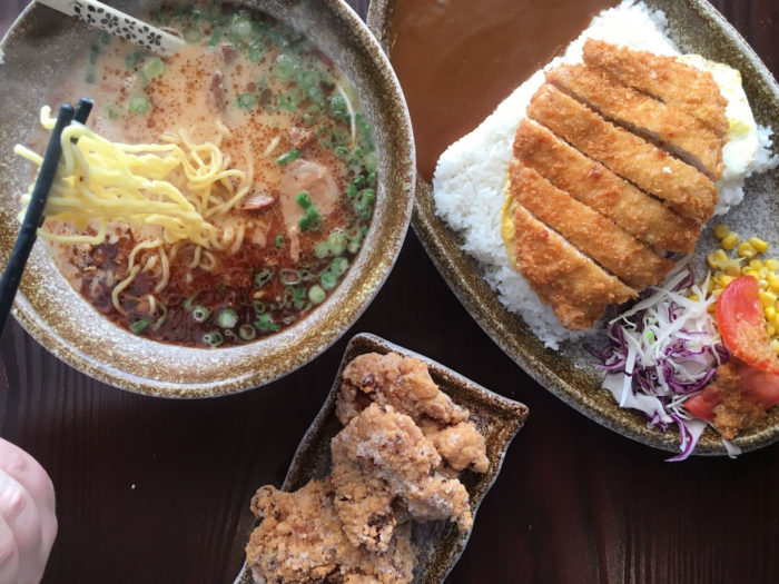 An overhead shot of soup and a rice dish from Kazoku Ramen